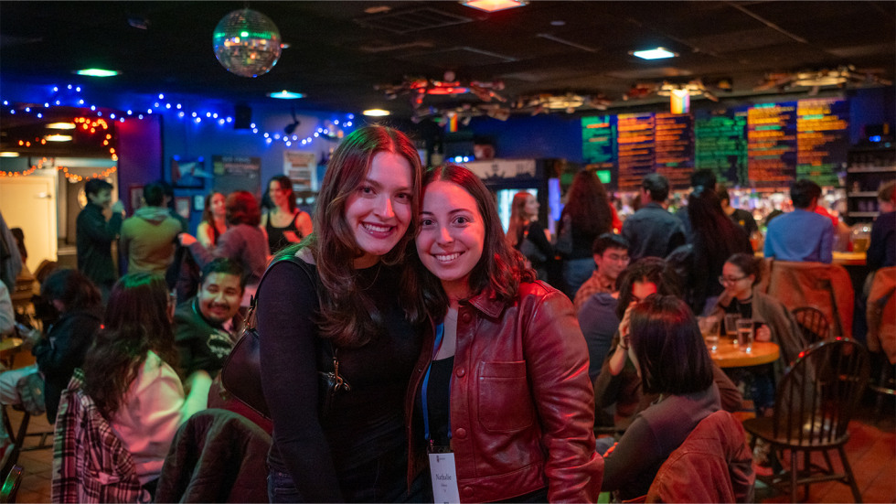 Two young alumni during the Young Alumni Social in the Grad Center Bar