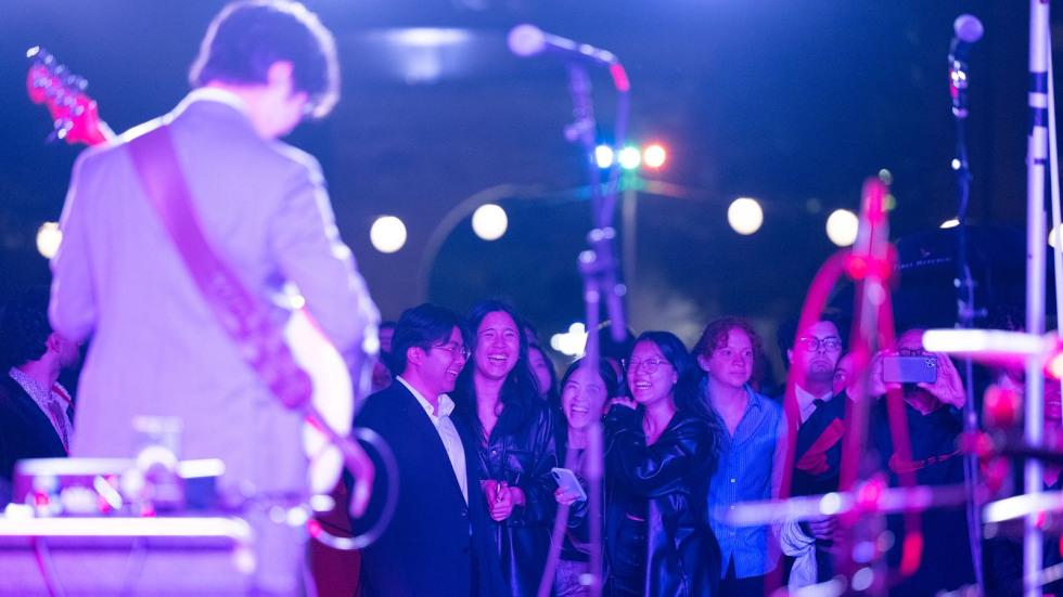 A bassist performs on stage during the Battle of the Bands in front of the Campus Dance audience