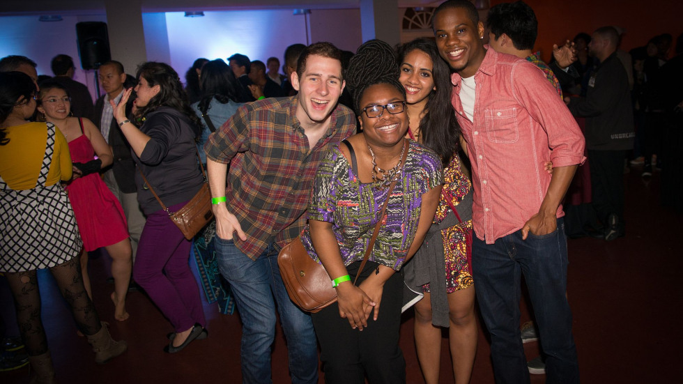 Four people smiling together during Funk Nite. 