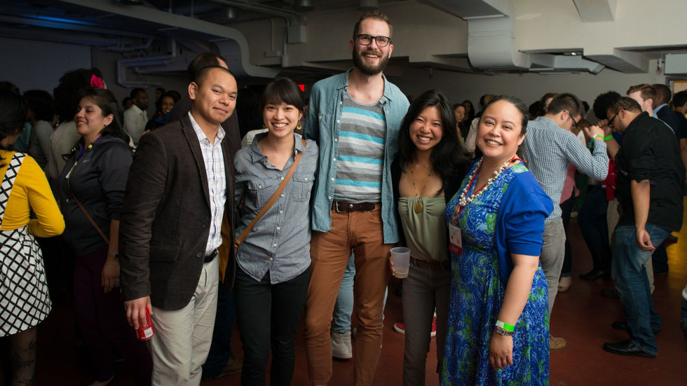 Five people standing together smiling during Funk Nite. 