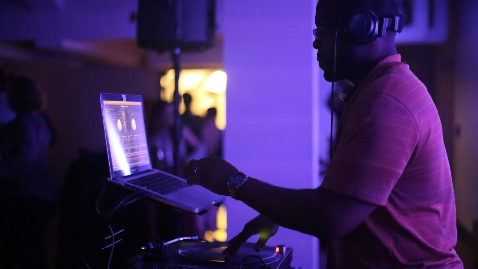 DJ Garf in a dimily lit area behind the turntables.