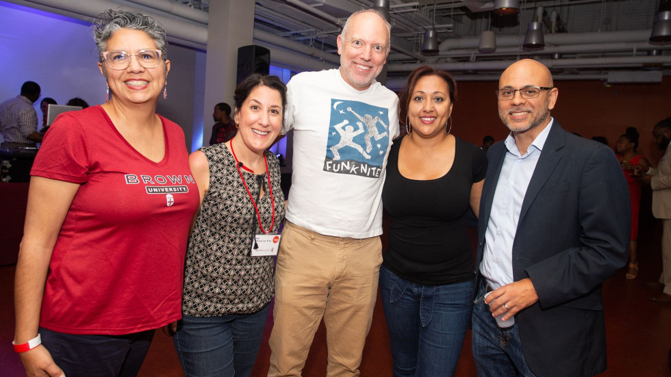 Five people standing together smiling with a person wearing a Funk Nite t-shirt. 