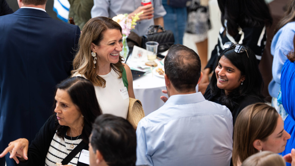Three people chatting and smiling during the Watson event.