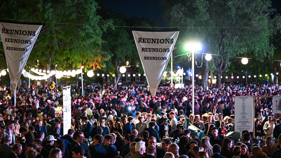 A crowd of Brunonians at Campus Dance under banners that say "Reunion"