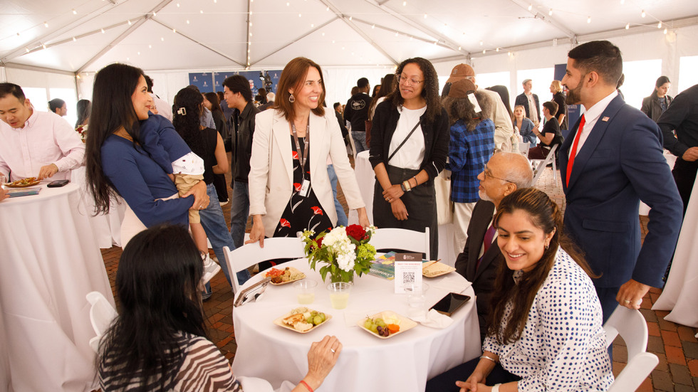 People gathered around a table at the SPH community celebration.