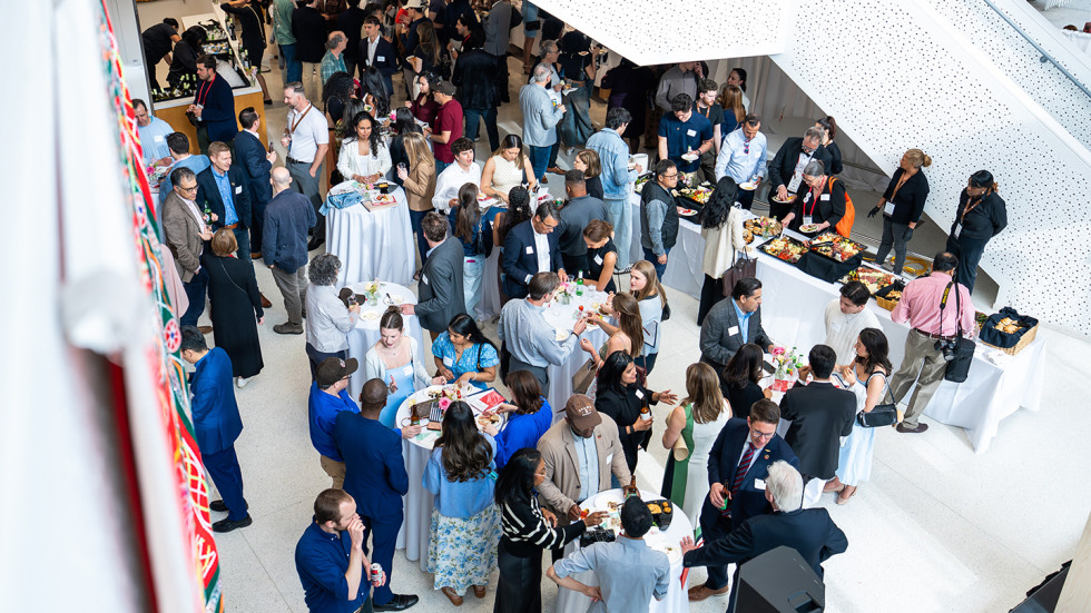 A large crowd celebrating during Watson School's event. 