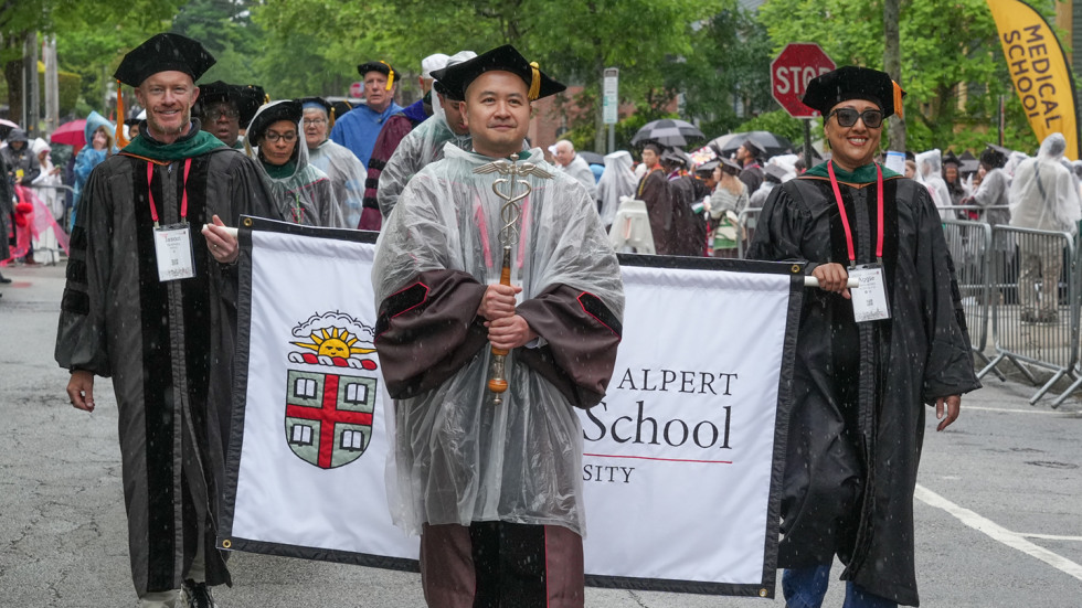 Andrew Young marching in front of the medical school banner.