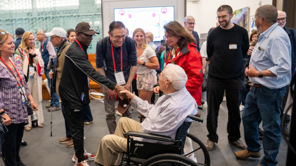 Hazeltine shaking hands with a guest at the celebration.