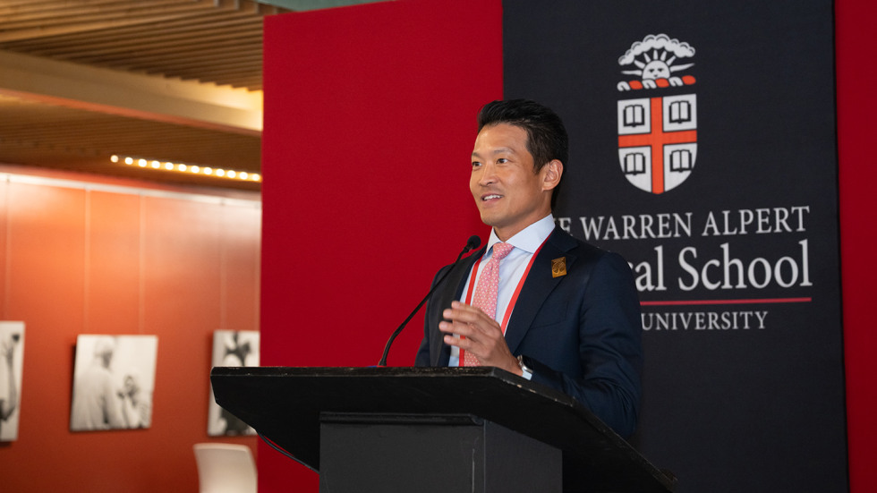 Peter Kim speaking at the podium during the awards presentation.