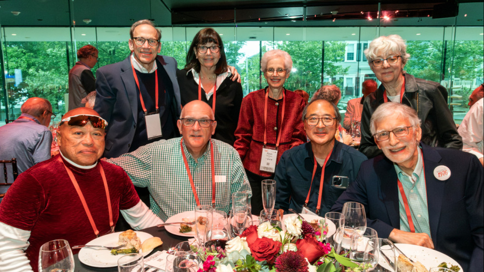 group of Reunion alums posing for a photo at dinner