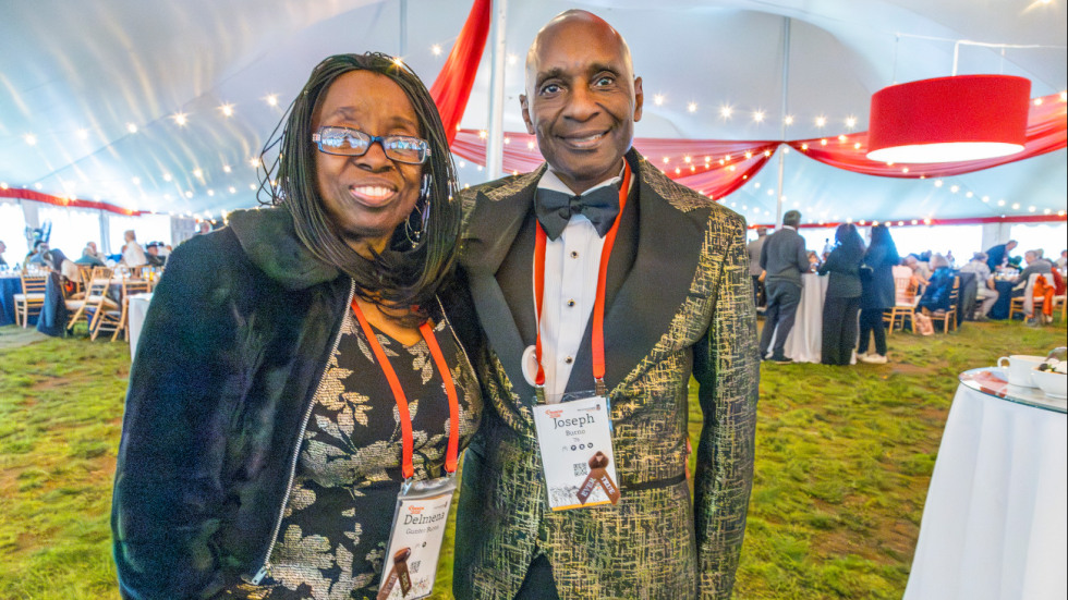 Alums pose inside tent on Pembroke field