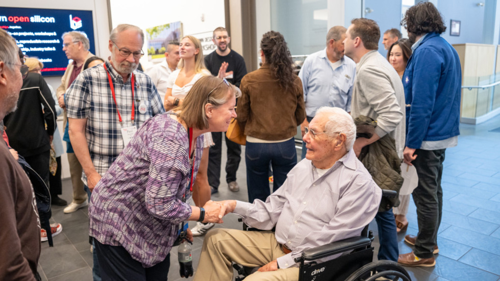 Hazeltine shaking hands with a woman.