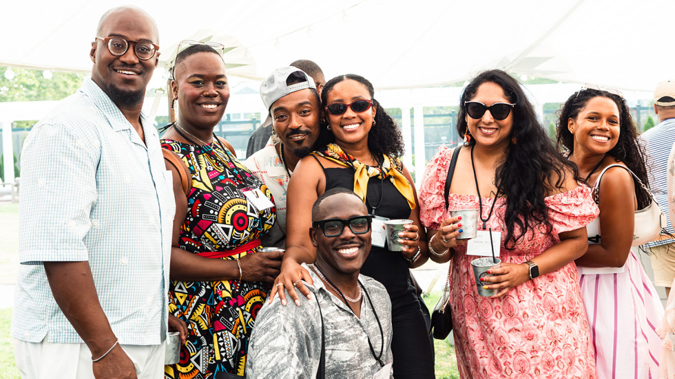 Seven attendees gathered together, with one person sitting in the center.
