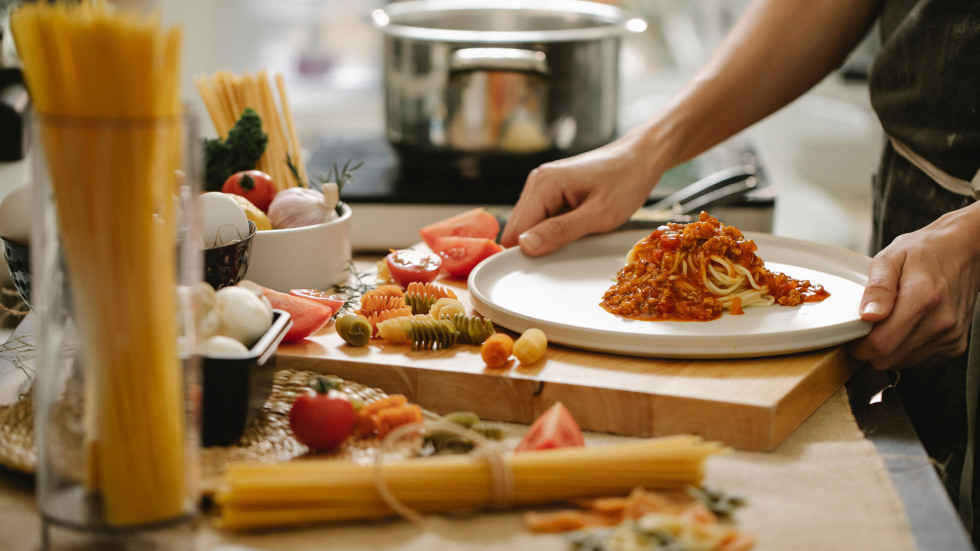 An Italian spaghetti dish being served on a table.