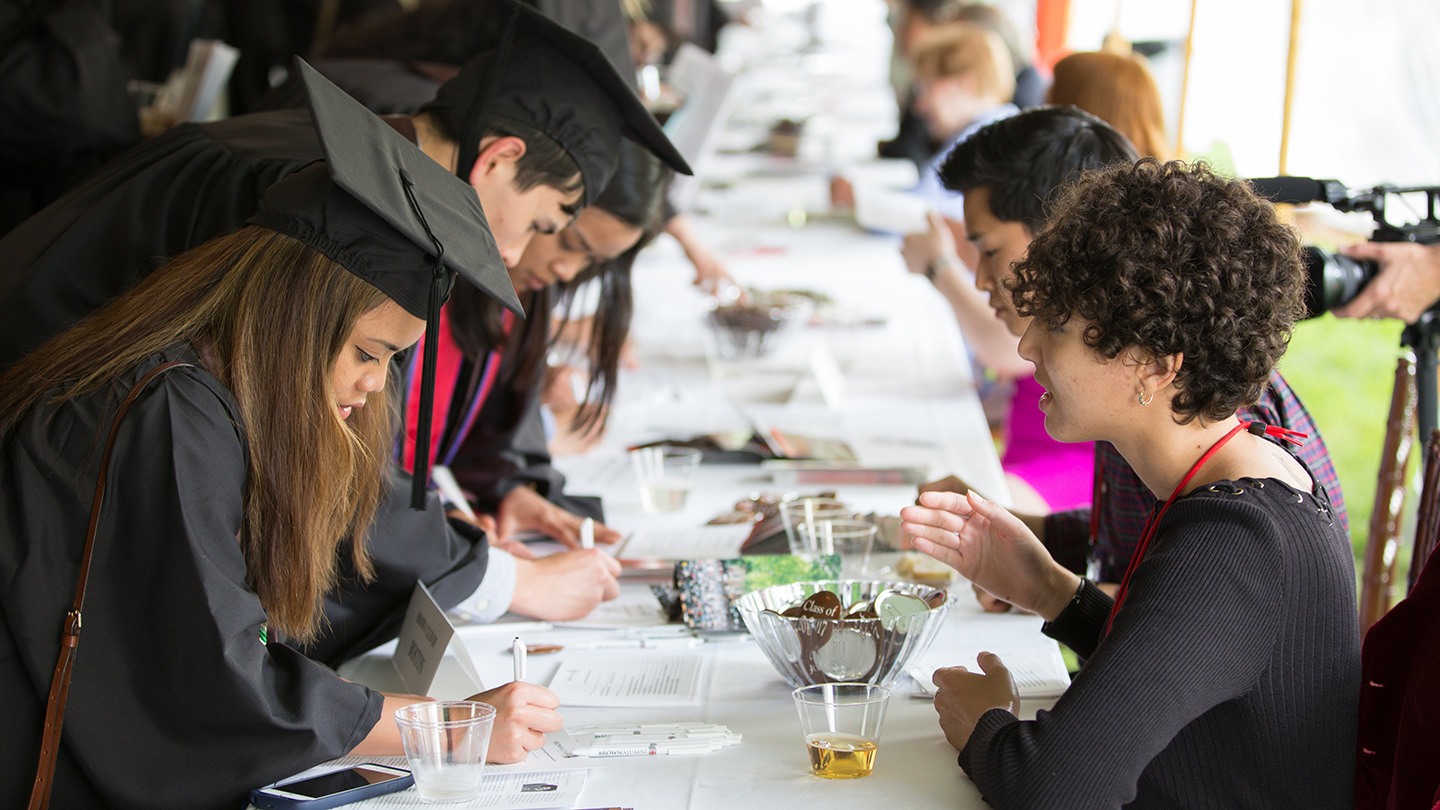 New alumni and volunteer connecting at Commencement.