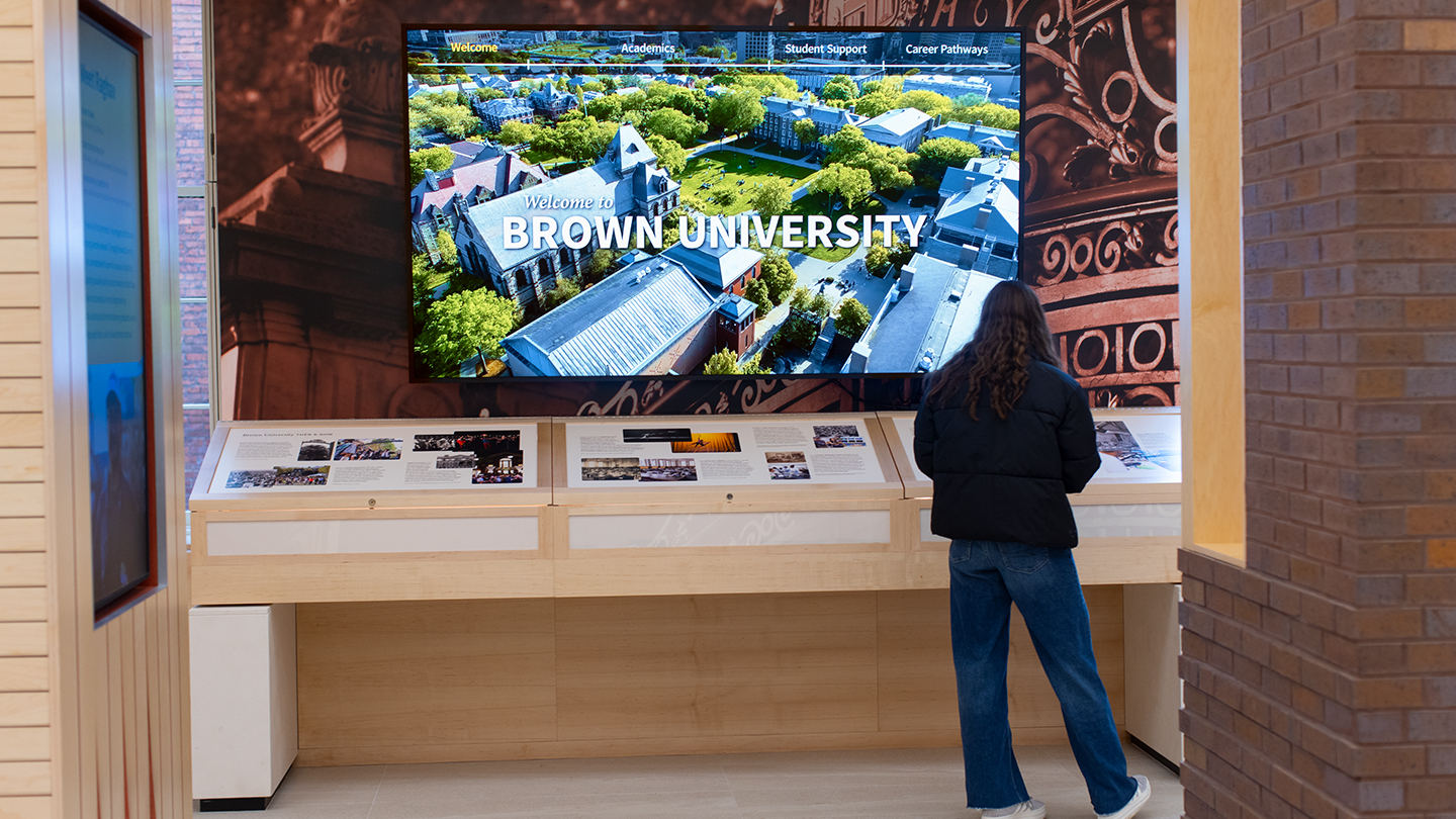 A young woman browsing an exhibit in Brown's new welcome center
