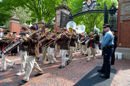 The Brown Band marching through the Van Wickle Gates in Commencement
