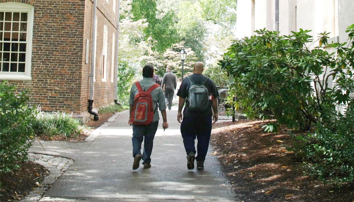 two students walk along path on the Main Green
