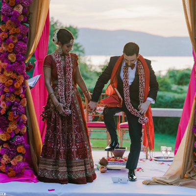 Jini Chatterjee ’10  (left) and James Witkin ’10 (right) at their wedding ceremony outdoors
