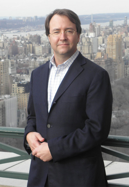 Joseph P. Healey P'22, P'24 posing with the city skyline behind him